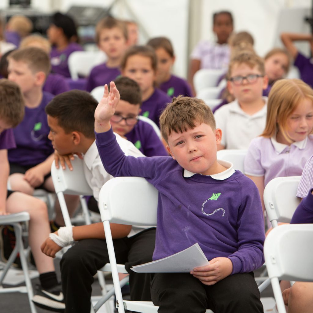 Boy enthusiastically engaging with bookfest